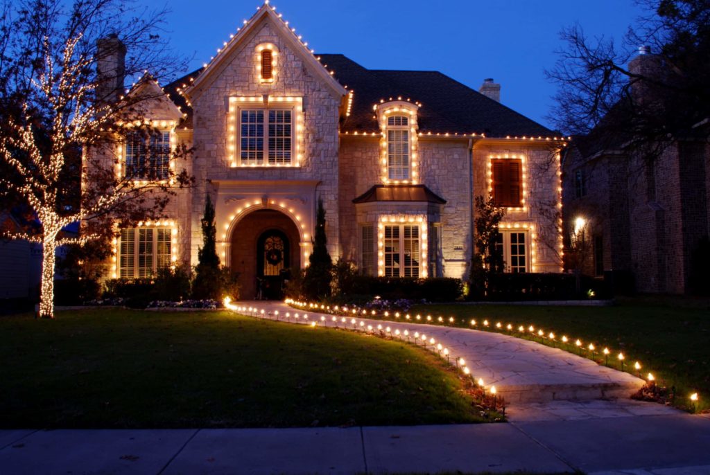 white holiday lighting on brick home